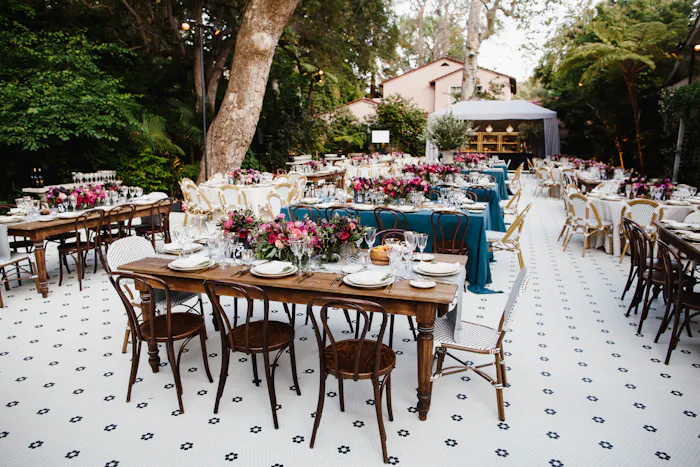 Tiled outdoor floor with wooden tables and chairs.