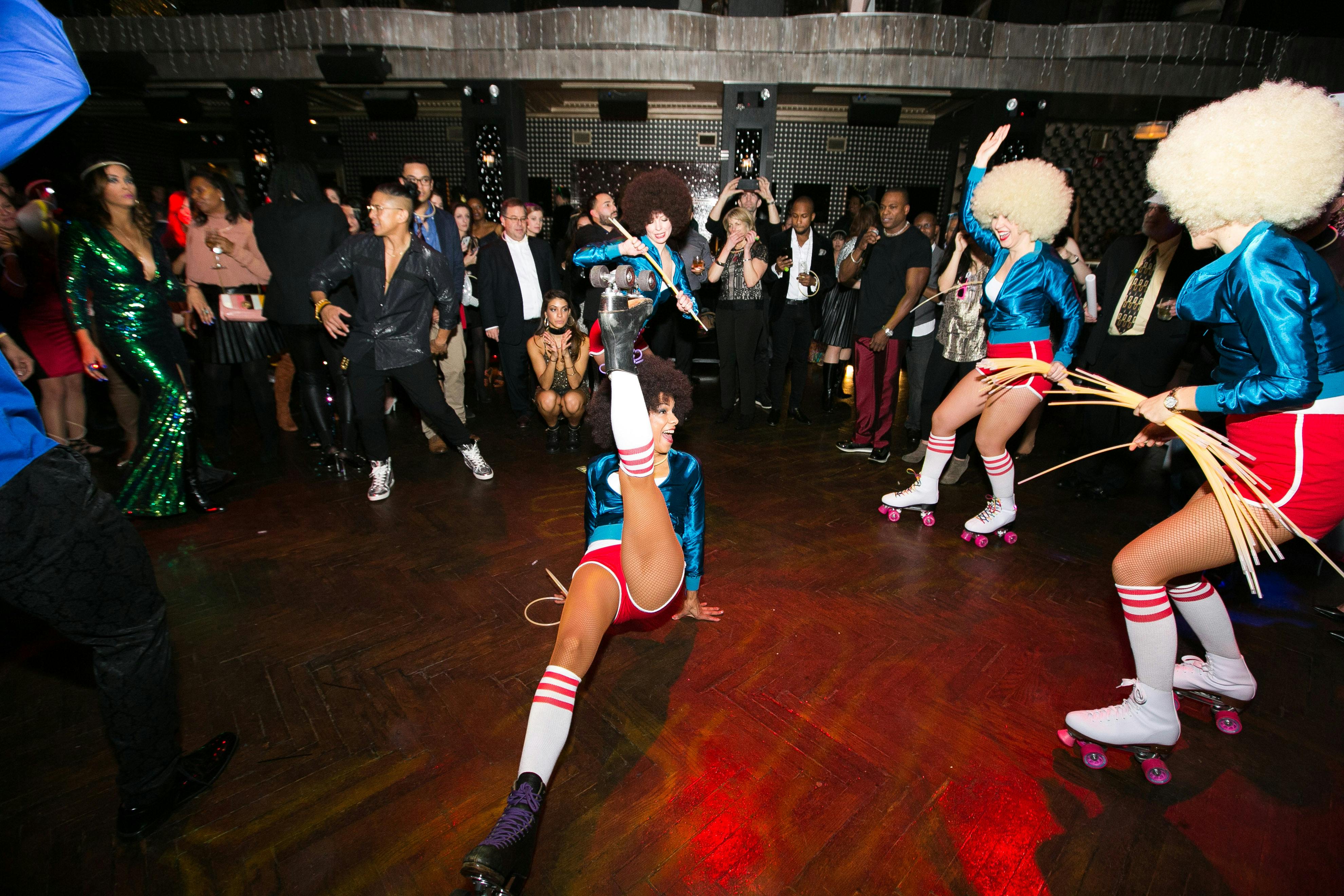 disco dancers entertain a crowd of people