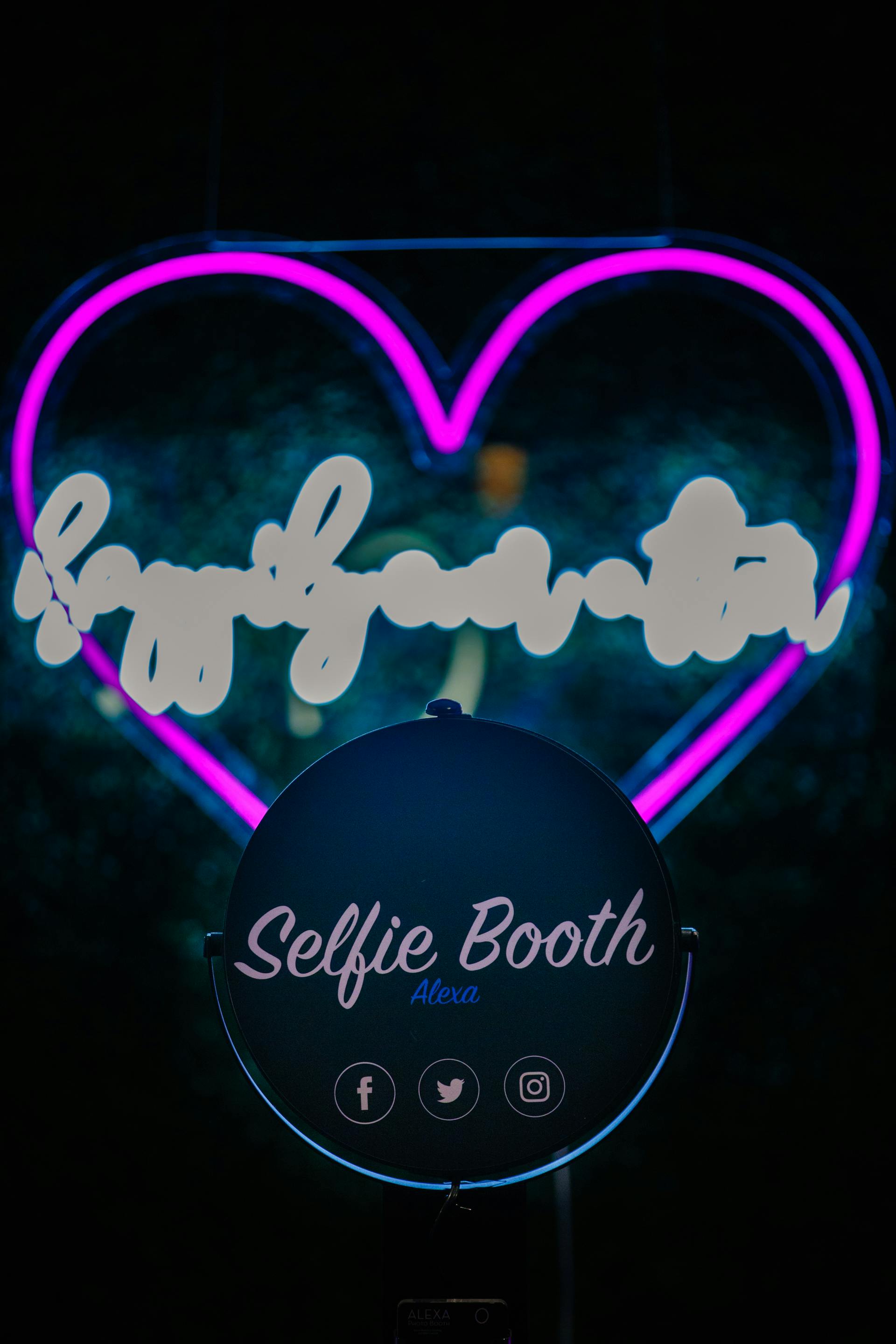 a neon heart advertising a selfie booth