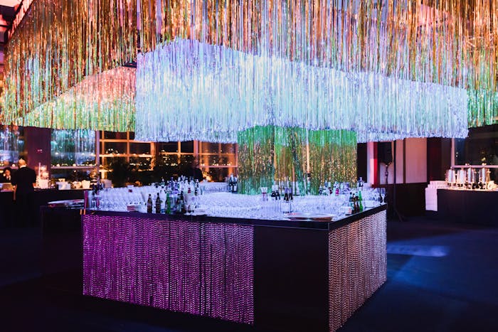 a bar surrounded by multicolored tinsel