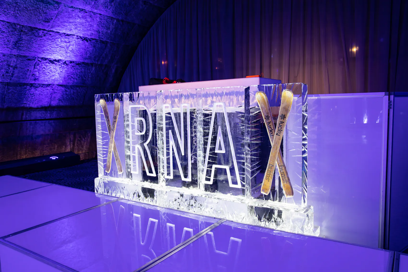 branded ice sculpture with purple dramatic lighting