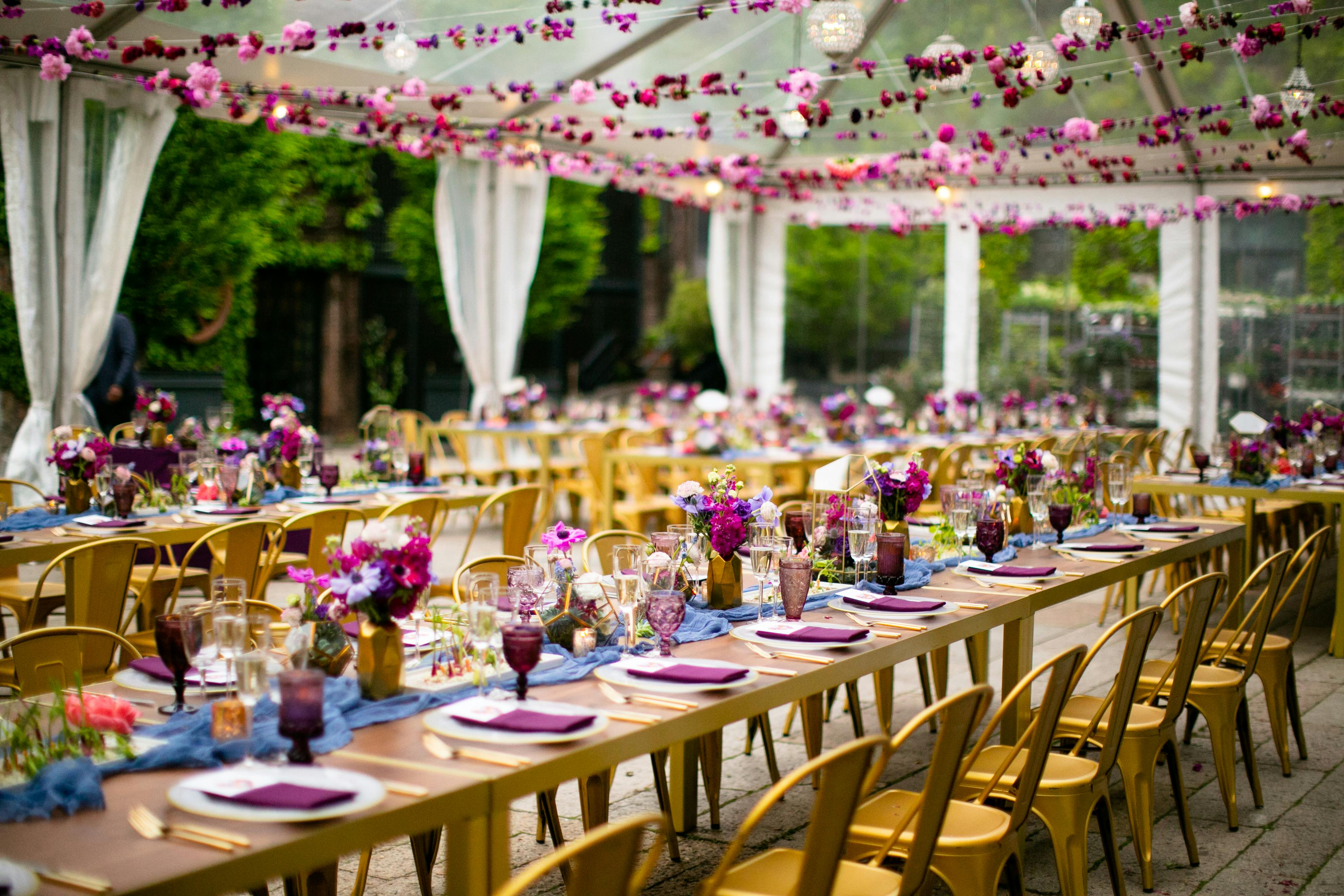 Wooden tables with pin accents and pink florals above