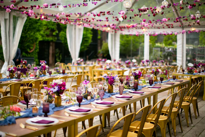 Wooden tables with pin accents and pink florals above