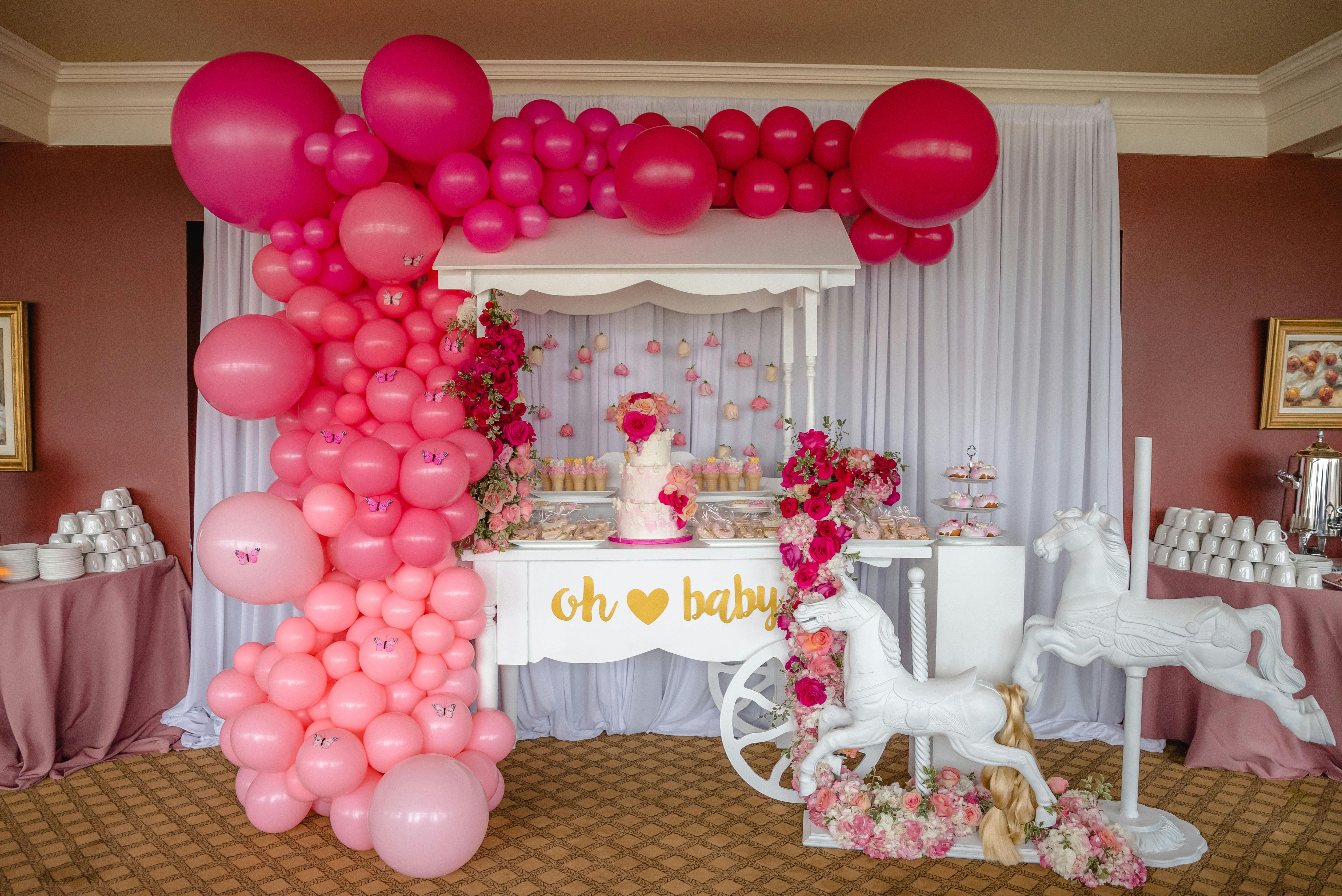 pink ombre balloon installation on baby shower dessert cart
