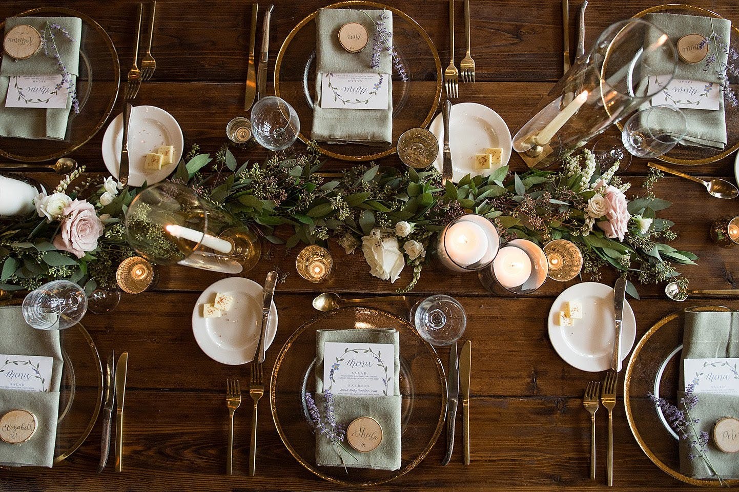 Overhead shot of a table set up with votive candles and greenery
