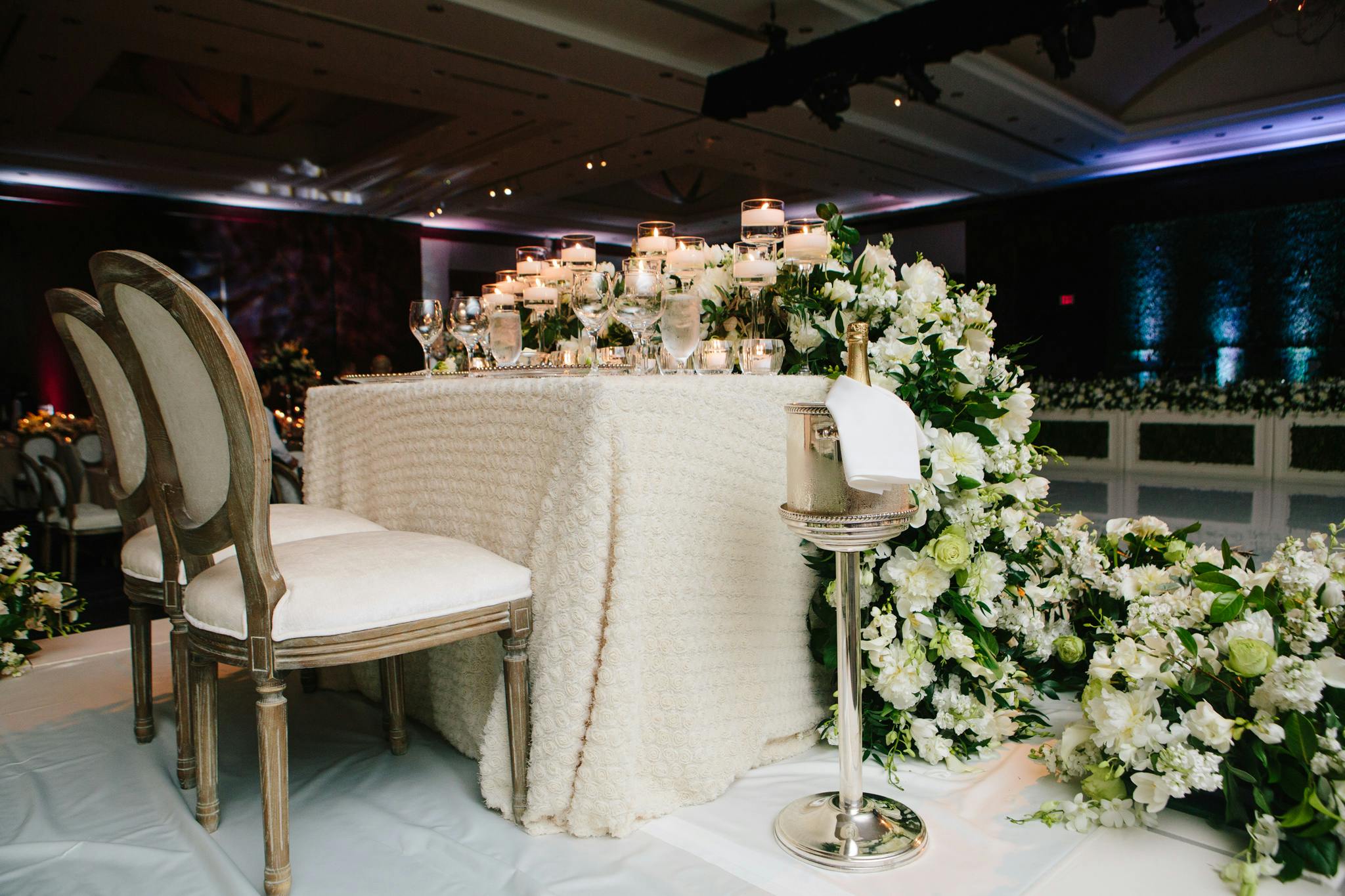 The bride and groom table with cascading white florals