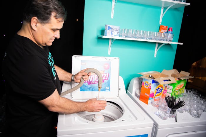 Man doing laundry at Museum of Party themed event | PartySlate