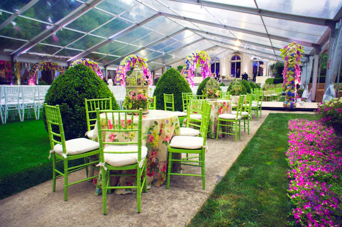 A clear tent with green furniture and ink accents.