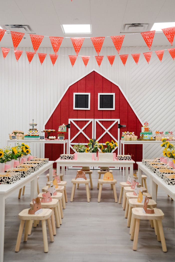 Barn themed party with red farm door and animal themed treats | PartySlate