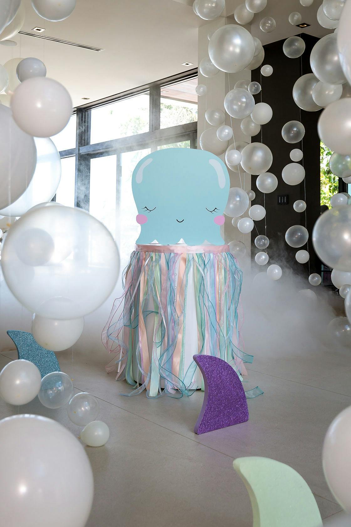 Baby shark sculpture surrounded by bubble balloons and smoke | PartySlate