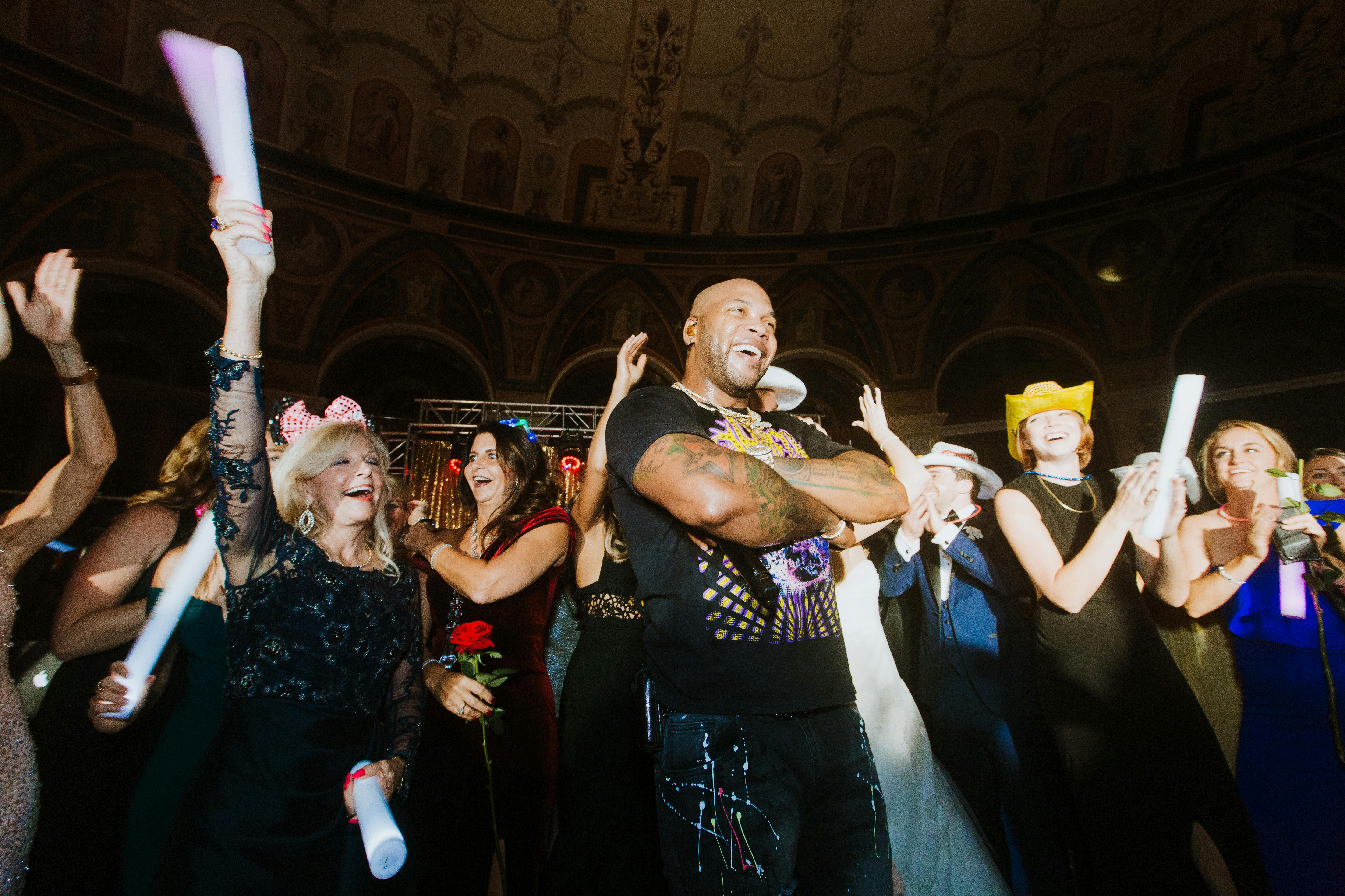 Flo Rida crosses his arms and poses for a photo with the crowd.