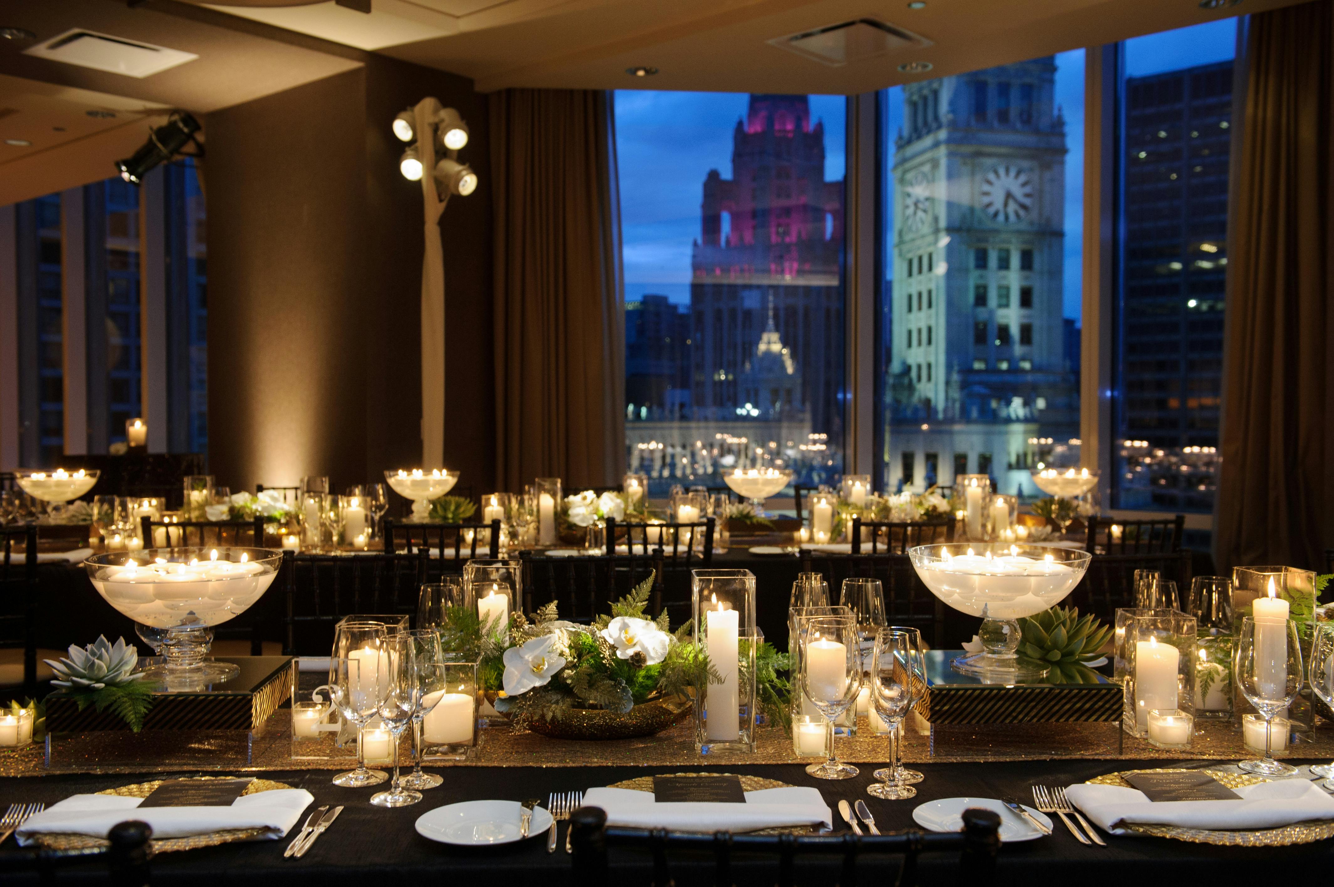 Table with large bowl of light and candles throughout room looks gold.